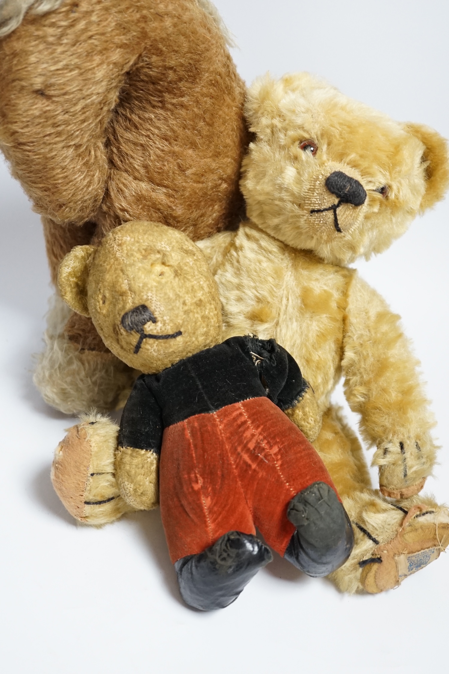 A Chad Valley teddy bear, 34cm high, a smaller bear in velvet clothes and a Merrythought horse